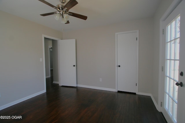 interior space featuring baseboards, a ceiling fan, and dark wood-style flooring