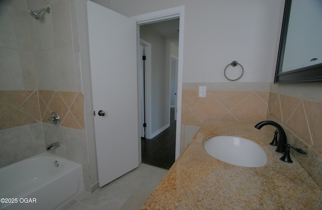 bathroom featuring a sink, a bathing tub, and tile patterned floors