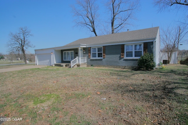 ranch-style house with brick siding, concrete driveway, a front yard, central AC unit, and an attached garage