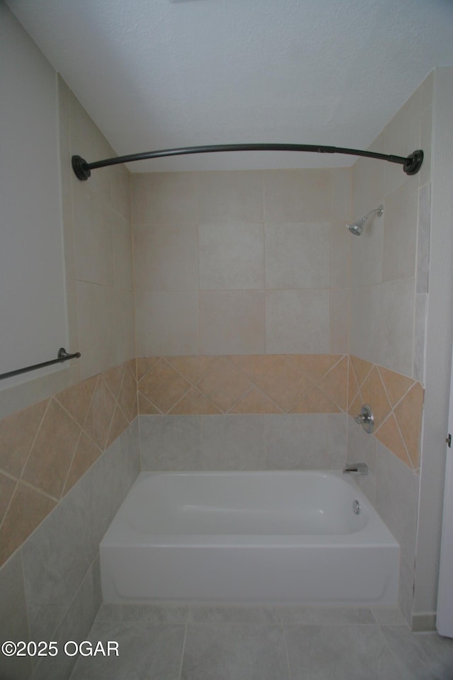 bathroom with tile patterned floors, shower / bathing tub combination, and a textured ceiling