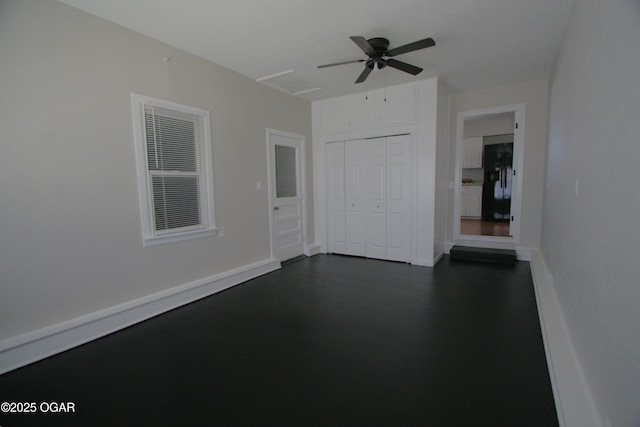 unfurnished room with baseboards and ceiling fan