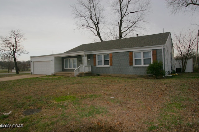 ranch-style home with brick siding, an attached garage, driveway, and a front lawn