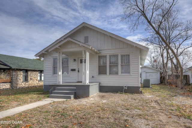 bungalow with an outdoor structure, cooling unit, and a shed