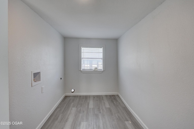 empty room with baseboards and light wood-style floors