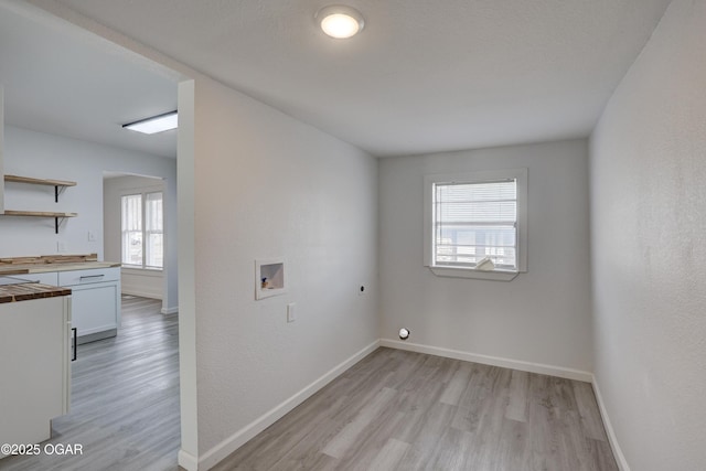 laundry area featuring hookup for a washing machine, light wood-style flooring, baseboards, and electric dryer hookup