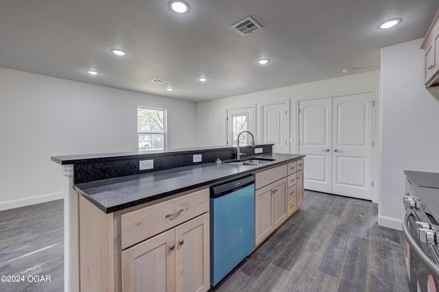 kitchen with visible vents, light brown cabinets, a sink, dishwashing machine, and range