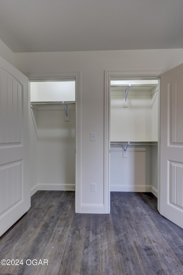 unfurnished bedroom with wood finished floors and baseboards