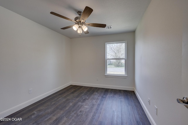 empty room with visible vents, ceiling fan, baseboards, and dark wood-style flooring