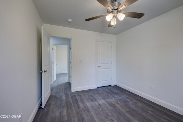 unfurnished bedroom with baseboards, dark wood-style flooring, and ceiling fan