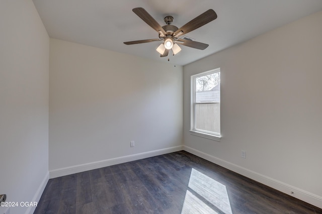 unfurnished room featuring a ceiling fan, baseboards, and dark wood-style flooring