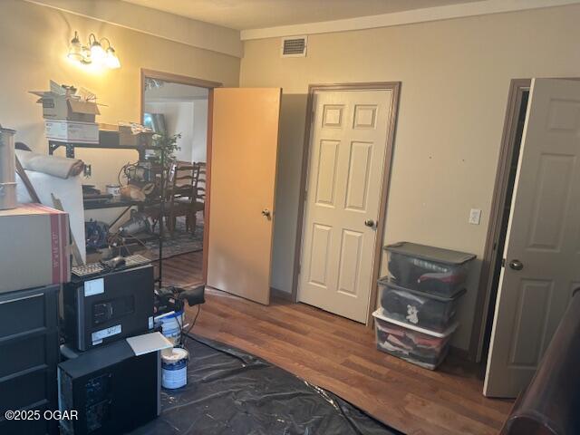 bedroom with visible vents and wood finished floors