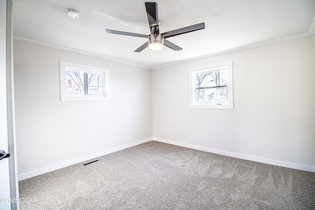 carpeted empty room with baseboards, ceiling fan, and ornamental molding