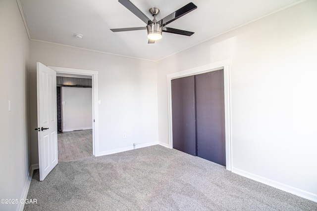 unfurnished bedroom featuring a closet, a ceiling fan, baseboards, and carpet floors