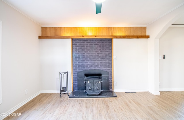 unfurnished living room with crown molding, baseboards, and wood finished floors