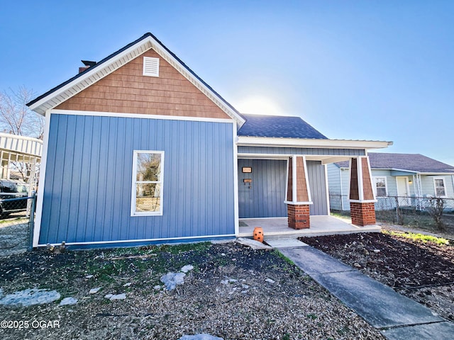 traditional-style house featuring fence and covered porch