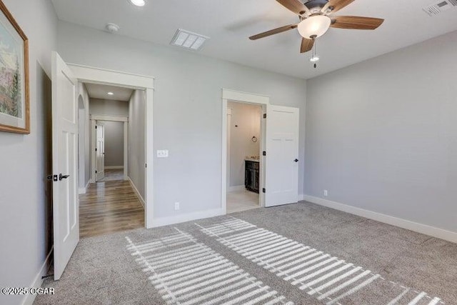 unfurnished bedroom featuring visible vents, baseboards, and carpet