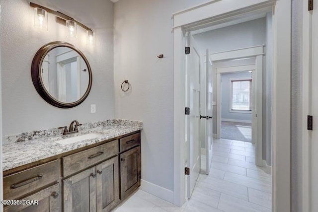 bathroom with vanity and baseboards