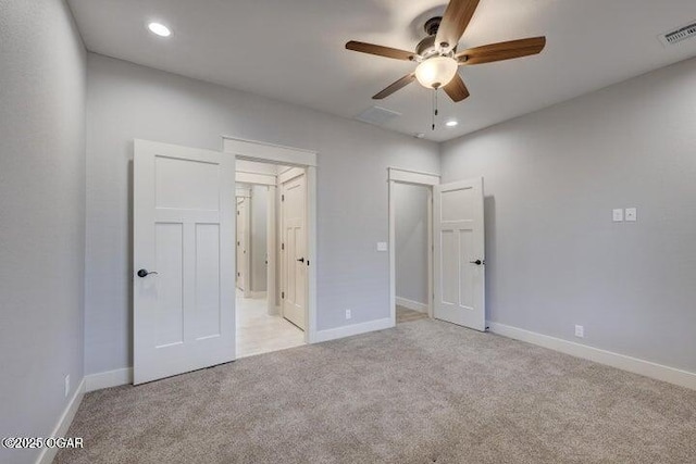 unfurnished bedroom featuring recessed lighting, visible vents, light colored carpet, and baseboards