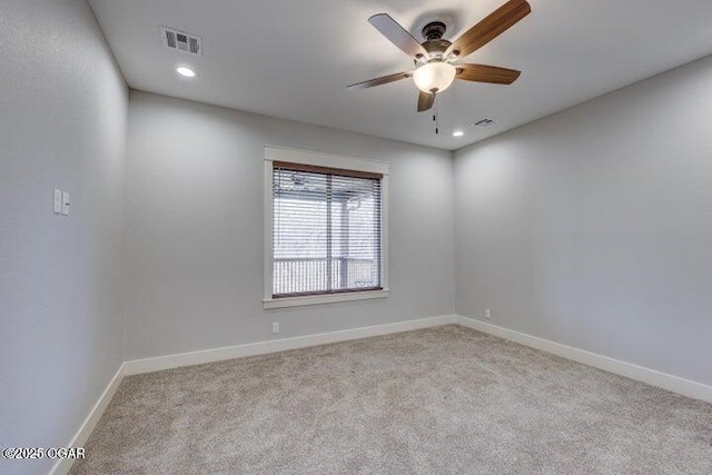 empty room with visible vents, baseboards, carpet floors, and a ceiling fan