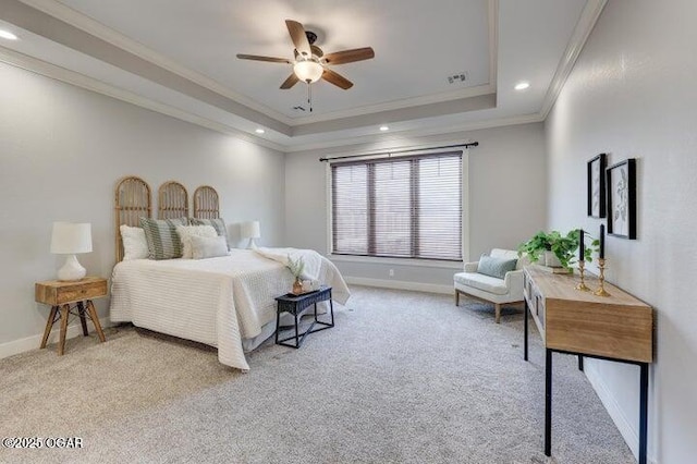 bedroom featuring a tray ceiling, crown molding, baseboards, and light carpet