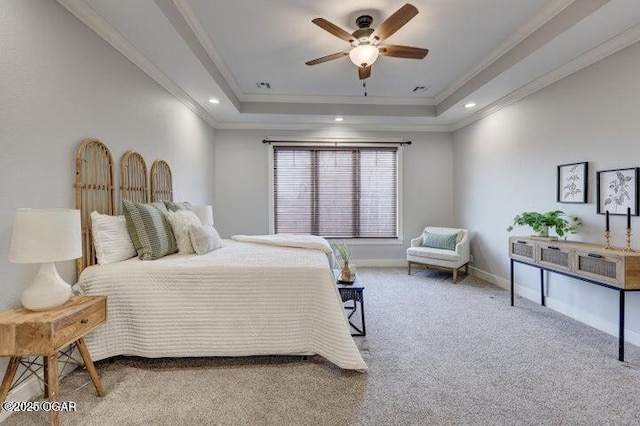 bedroom featuring a tray ceiling, crown molding, baseboards, and carpet floors