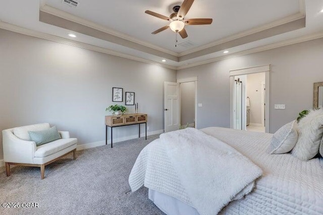 bedroom featuring visible vents, light colored carpet, baseboards, and a tray ceiling