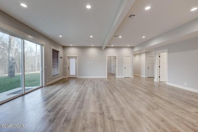 unfurnished living room featuring recessed lighting, baseboards, and light wood finished floors