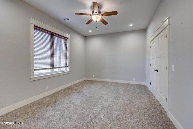 carpeted spare room featuring visible vents, recessed lighting, baseboards, and a ceiling fan