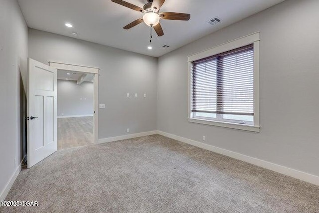 spare room with visible vents, a ceiling fan, recessed lighting, carpet flooring, and baseboards