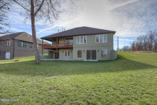 back of house featuring a yard, a wooden deck, and a patio area