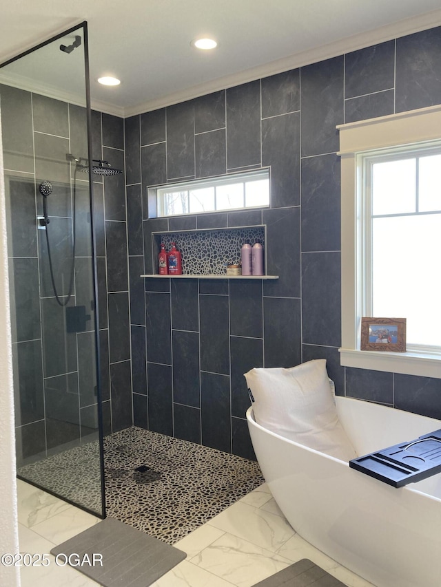 bathroom with a soaking tub, a healthy amount of sunlight, marble finish floor, and a walk in shower