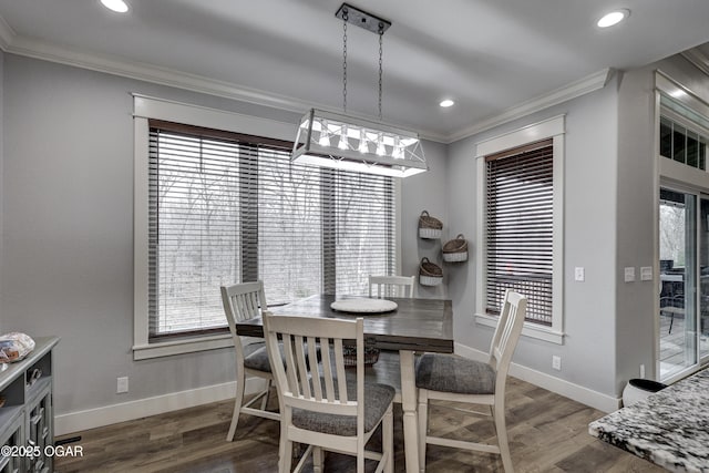 dining room with plenty of natural light, wood finished floors, and ornamental molding