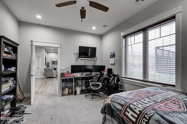 carpeted bedroom featuring a ceiling fan, recessed lighting, beverage cooler, and visible vents