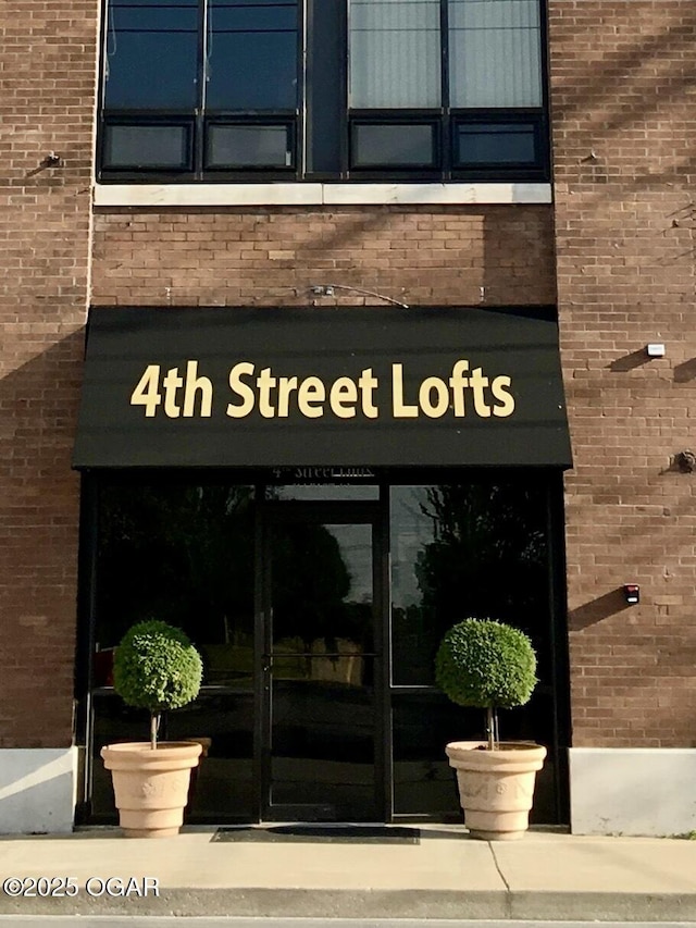 entrance to property with brick siding