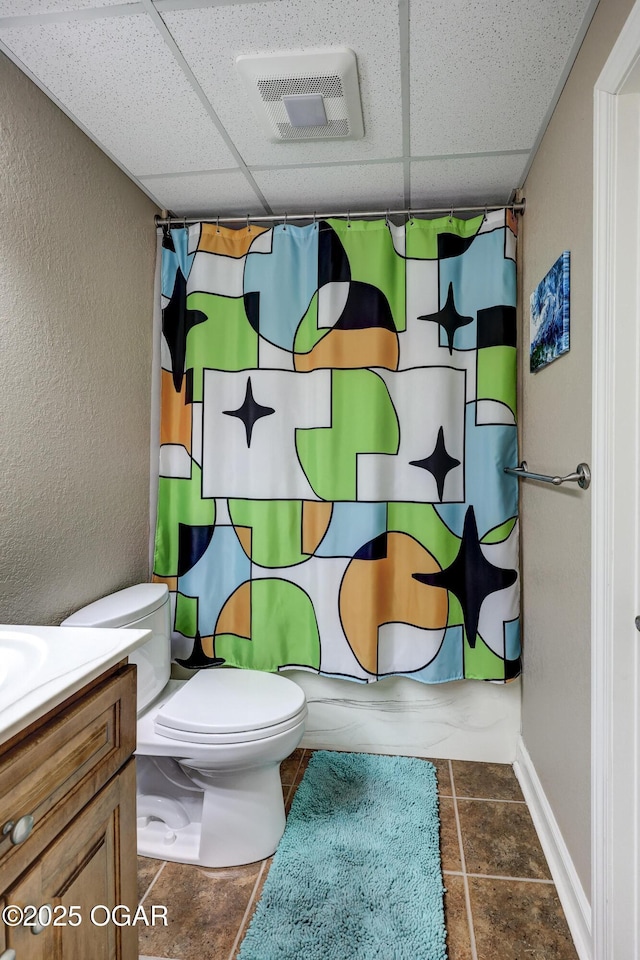 full bath with visible vents, toilet, vanity, and a paneled ceiling