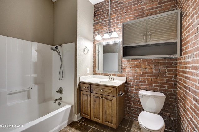 bathroom featuring vanity, tile patterned floors, toilet, and brick wall