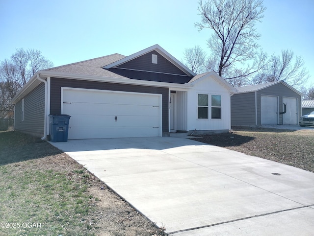 single story home with concrete driveway and an attached garage