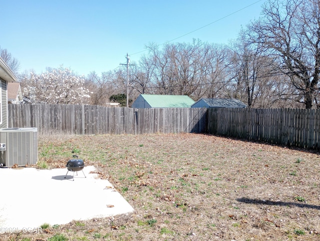 view of yard featuring a patio, central AC unit, and a fenced backyard