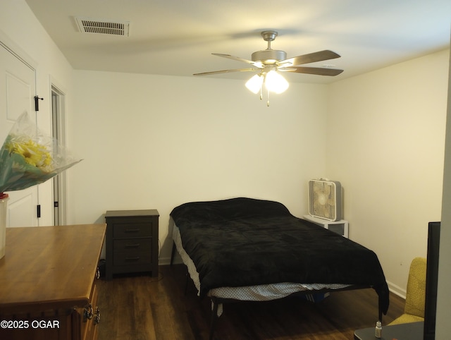 bedroom with visible vents, ceiling fan, and wood finished floors