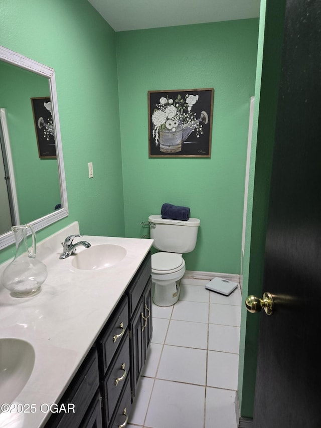 full bathroom with tile patterned flooring, double vanity, toilet, and a sink