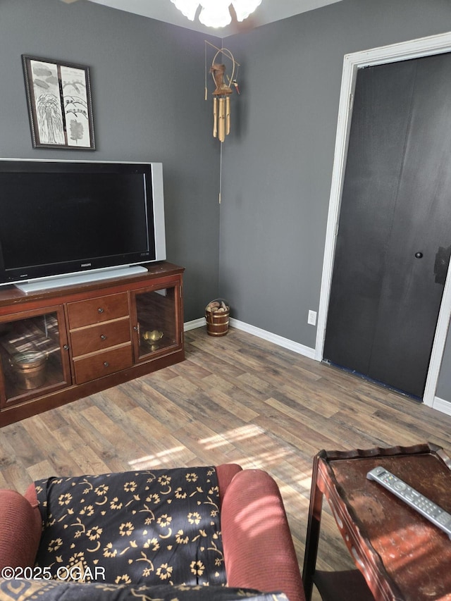 living room featuring baseboards and wood finished floors