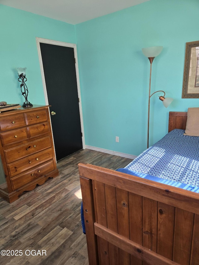 bedroom with dark wood-style flooring