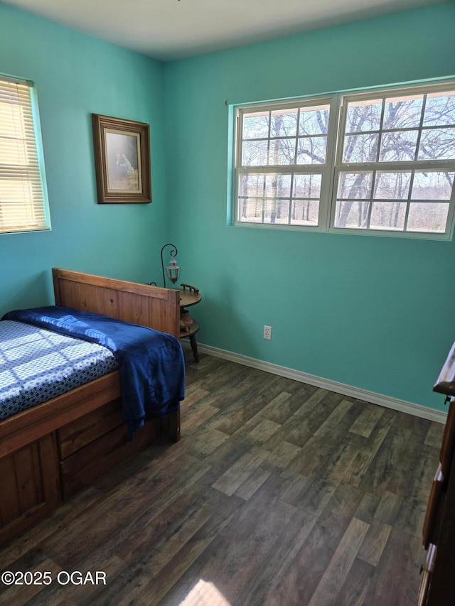 bedroom with dark wood-style floors and baseboards