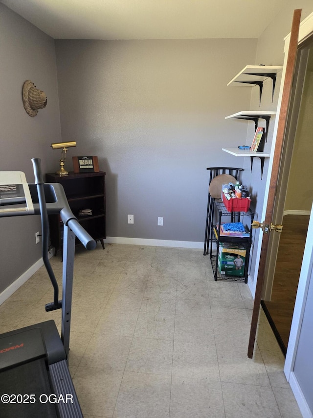 workout room featuring baseboards