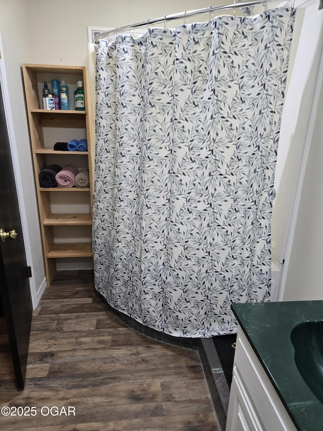 bathroom with a shower with curtain, wood finished floors, and vanity