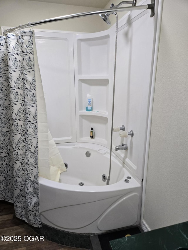 full bathroom with wood finished floors and shower / tub combo