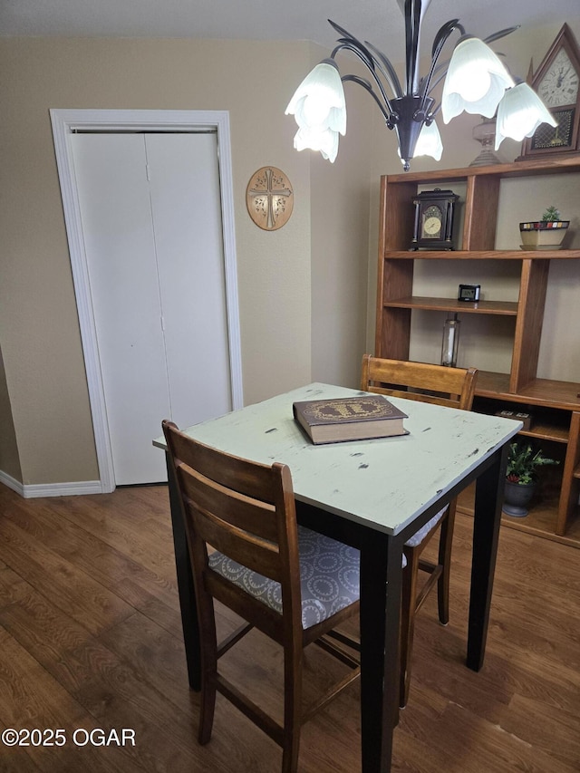 dining room with a notable chandelier and wood finished floors