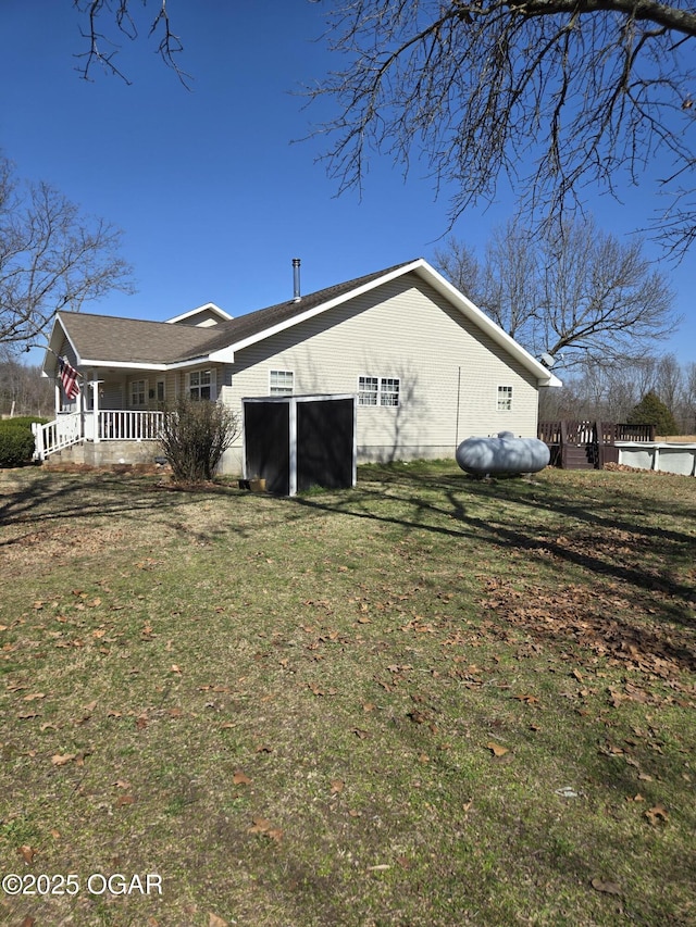 exterior space featuring covered porch and a lawn