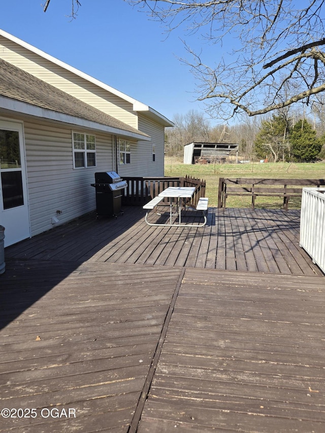 wooden terrace featuring outdoor dining area and a grill