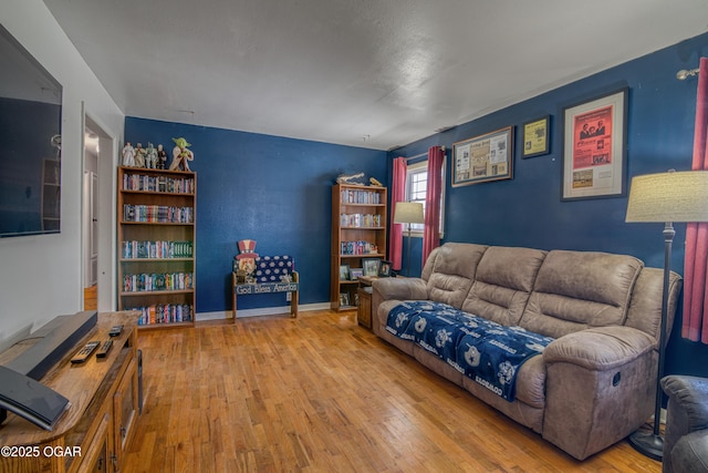 living room with baseboards and wood-type flooring